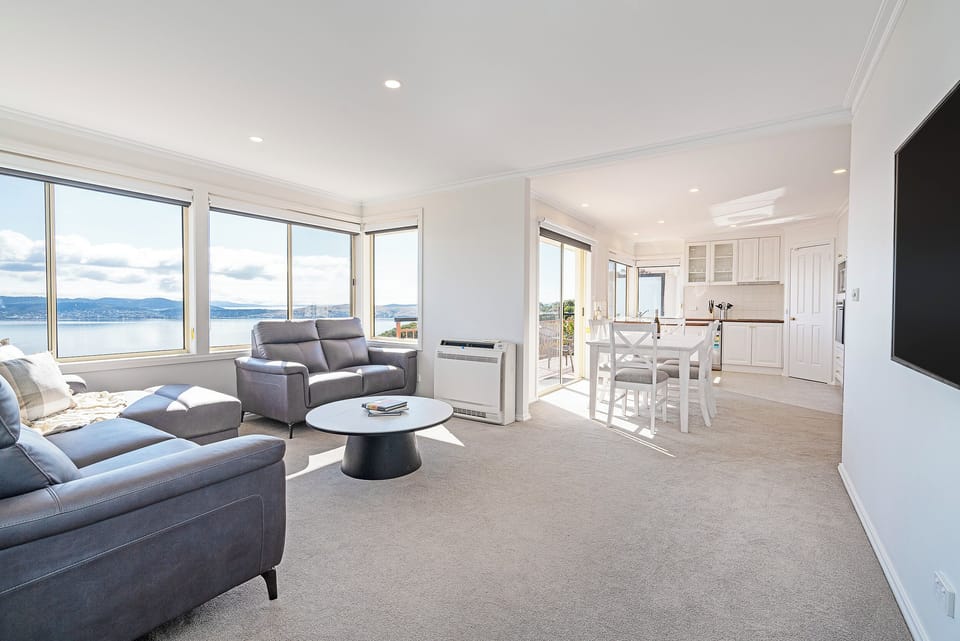 Settle into the light-filled living area, with wide river and city views that elevate everyday moments into something memorable.