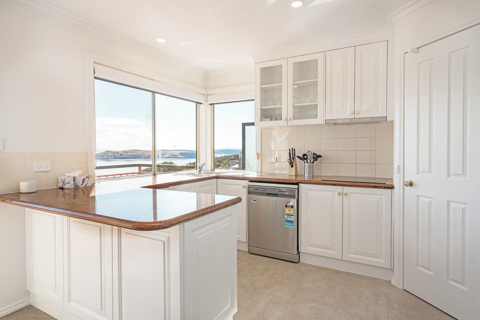 Prepare meals comfortably in the modern kitchen, with ever-present views across the Derwent as your backdrop.