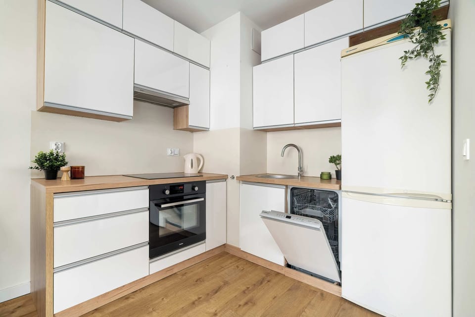 Modern kitchen area with bright cabinets and contemporary design.