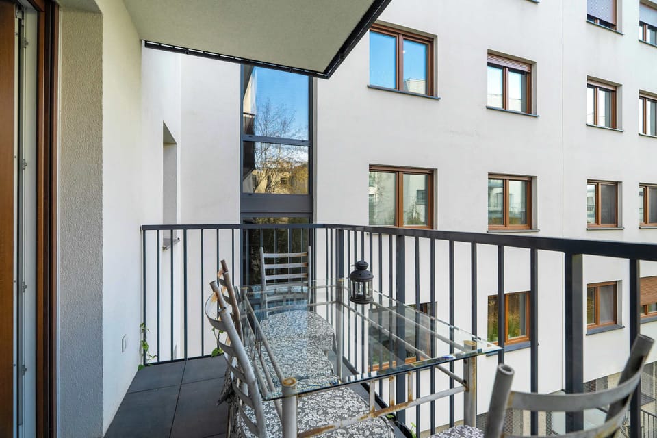 Balcony space with modern railings and garden views.
