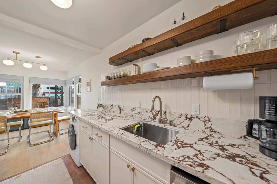 Fully equipped kitchen with sleek countertops & open shelving