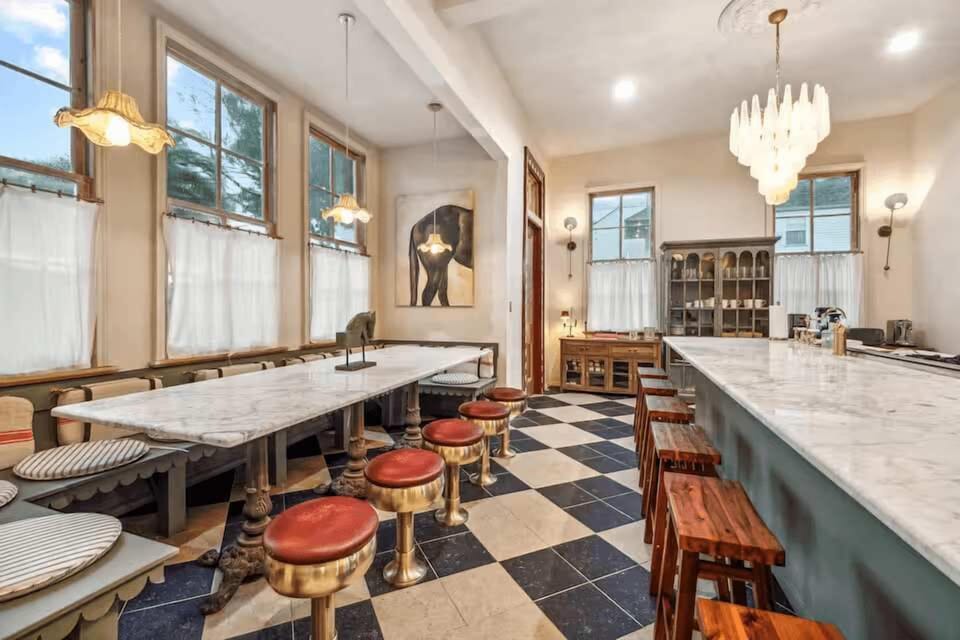 Spacious kitchen and dining area with marble tables and café-style seating.