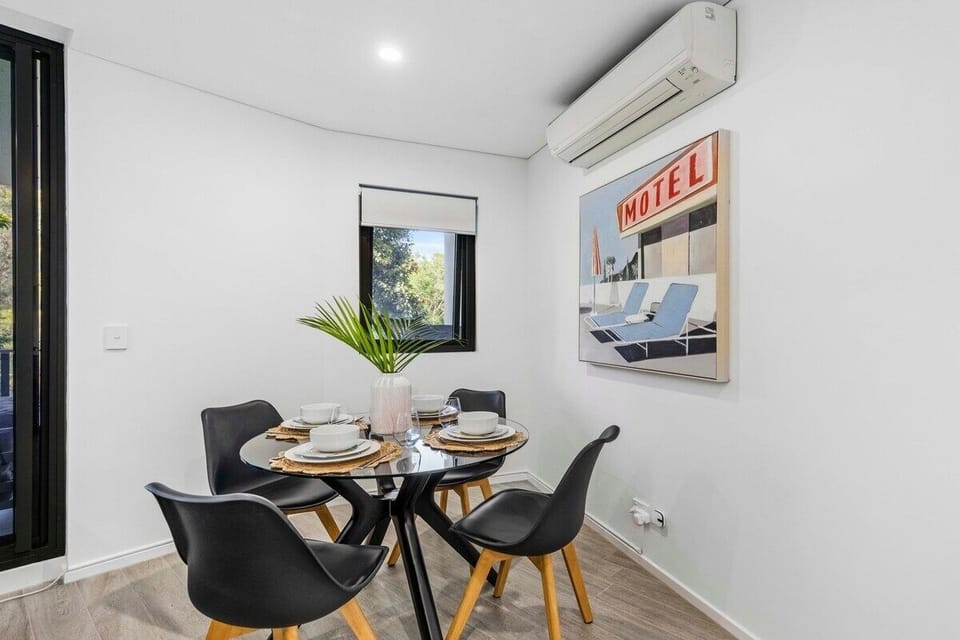 Dining table beside the kitchen and lounge for easy shared meals.