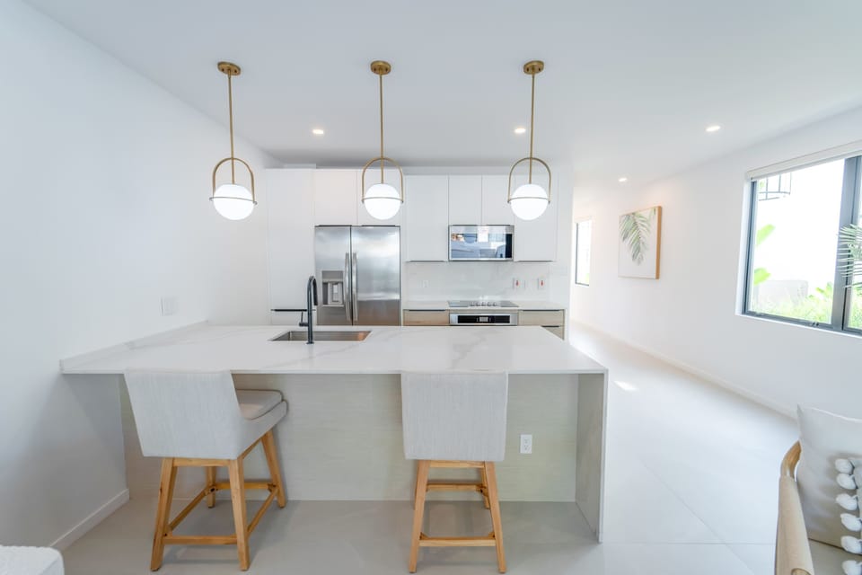 Kitchen: Open-concept living area with modern Caribbean flair, perfect for gatherings