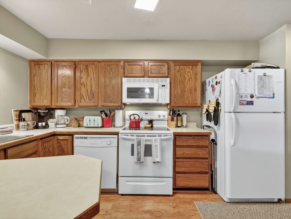 Your fully equipped kitchen awaits with warm oak cabinetry and all the essentials for cooking memorable meals.