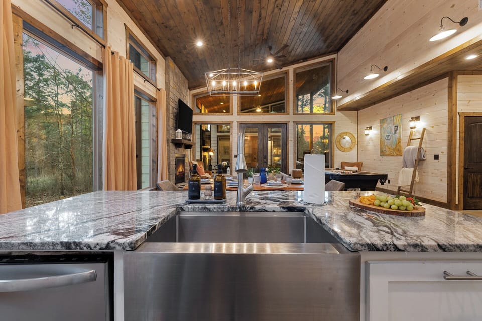 Sunlight dances across marble counters and warm wood tones, setting the scene for effortless meals and connection.