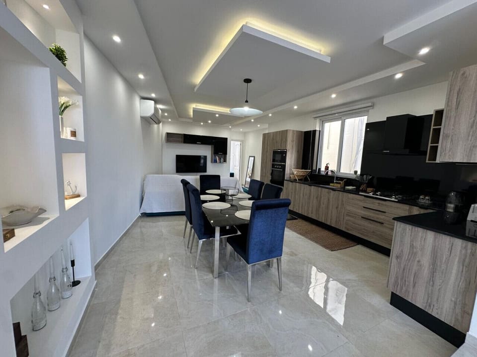 Sleek modern kitchen with a dining table for family or friends.