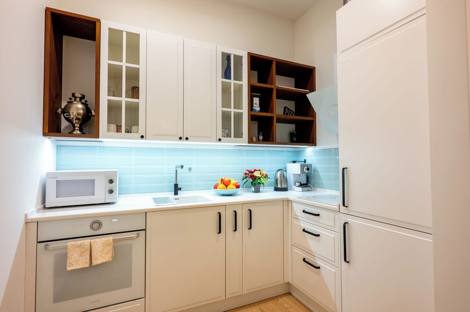 Fully equipped kitchen with stove, microwave, coffee maker and water boiler.