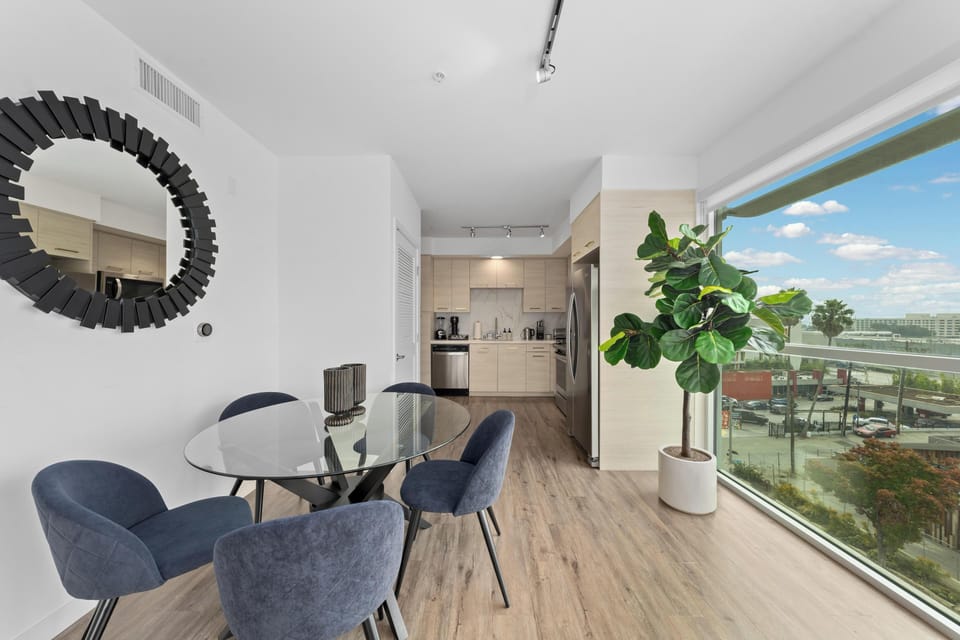 Sleek glass table and elegant chairs create a chic ambiance.
