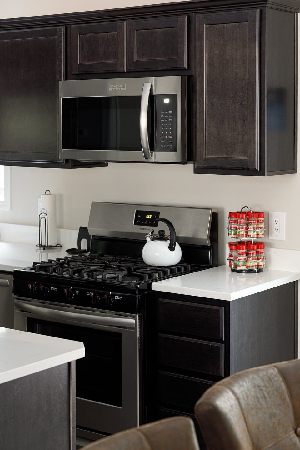 Gas stove w/ sleek finishes, perfect for home-cooked meals & morning coffee.