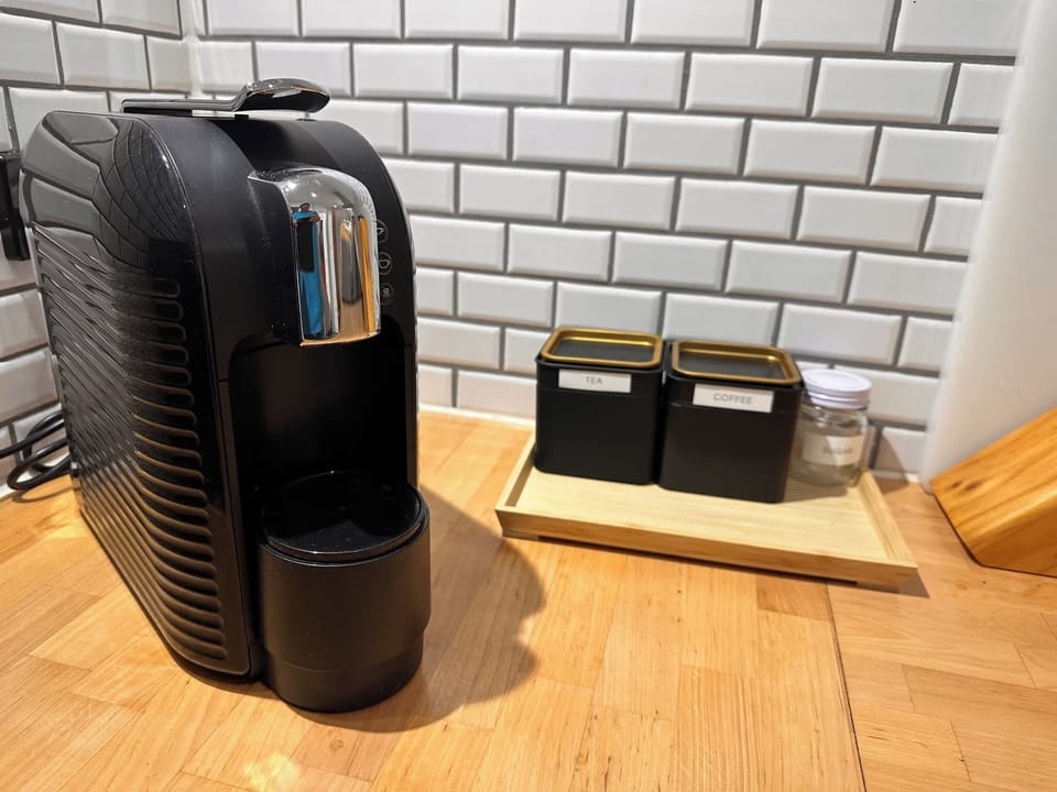 Coffee machine setup with mugs and kitchen essentials.