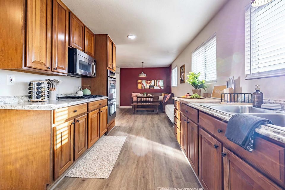 Cook, dine, and connect! This warm and inviting, fully equipped kitchen seamlessly flows into a charming dining space, ideal for shared moments.