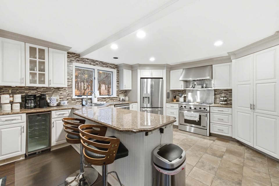 Spacious, fully equipped kitchen with gas range, island seating, and everything needed to cook for a crowd