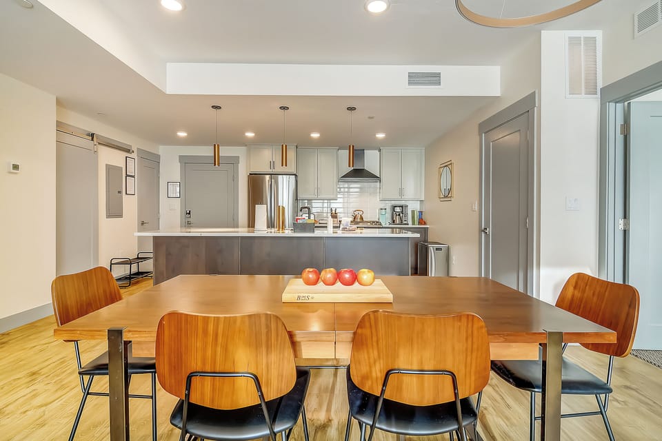 You'll love gathering around this stylish dining table, perfectly positioned to connect with the sleek kitchen for effortless entertaining.