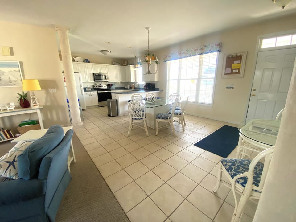 open walk space with kitchen/dining area bordering living room