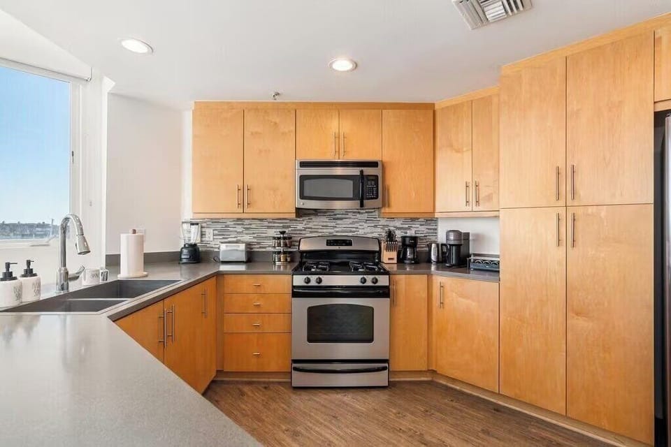 Fully equipped chef's kitchen with stainless steel appliances and gas range