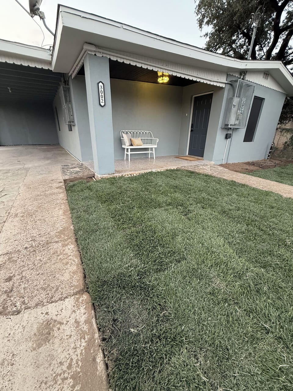 A seating area in the front yard provides a perfect spot to relax and unwind.