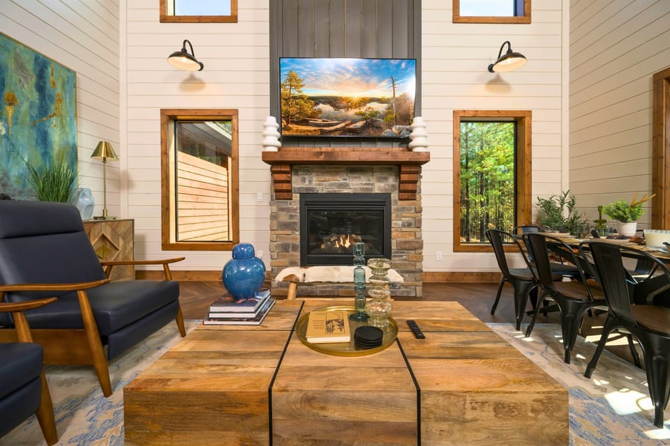 Living Room: Bright spaces with chic decor—unwind beside the stunning fireplace and nature views!