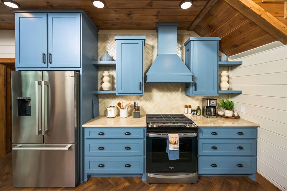Kitchen: Whip up delightful meals in this stylish kitchen with stunning blue cabinetry and modern touches!
