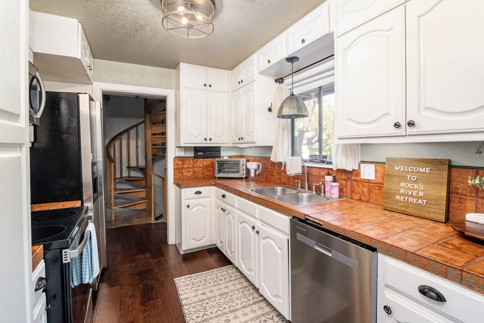 A well-stocked kitchen with modern appliances and rustic charm—ideal for preparing meals for multiple families, with easy access to all floors.