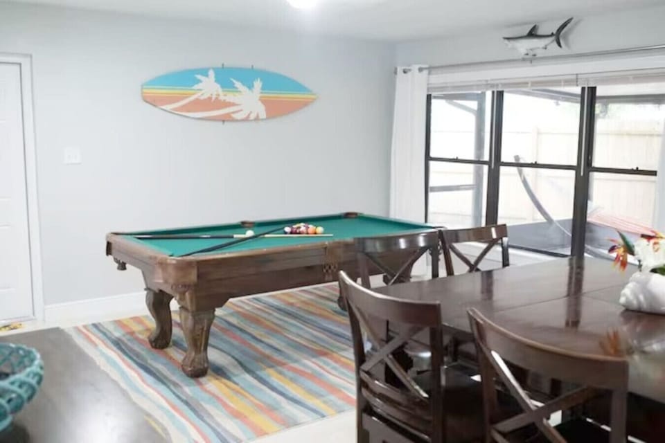 Rack `em up with a view!  Our pool table area is a stylish haven with views onto the covered patio, arcade game room, and a smart TV. Open to the kitchen and dining area, it`s a game night paradise! #GameOn #EntertainmentHub