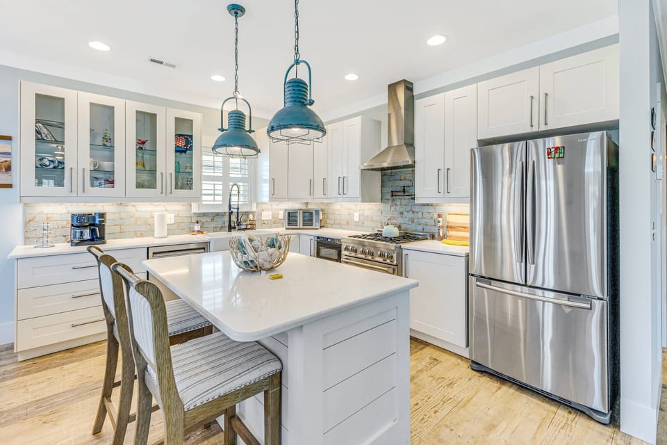 Modern kitchen with island seating and complete appliances.