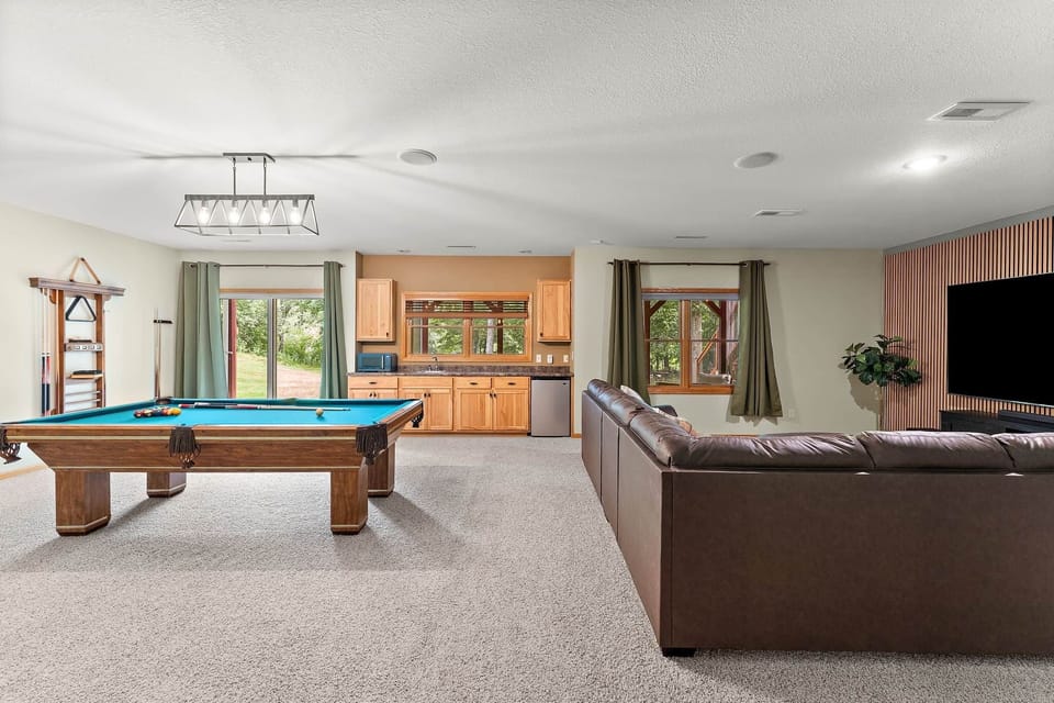 The game room includes 98" television and pool table.