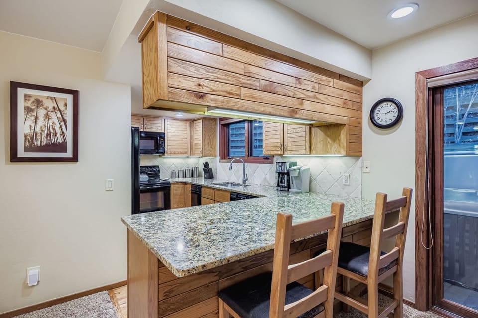 Seating for 2 at breakfast bar and 6 more at dining table.