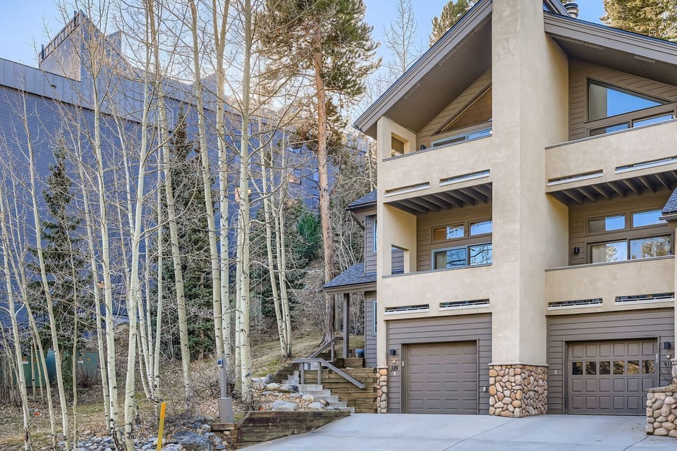 Heated driveway and walkway with one car garage and parking pad for an additional car.