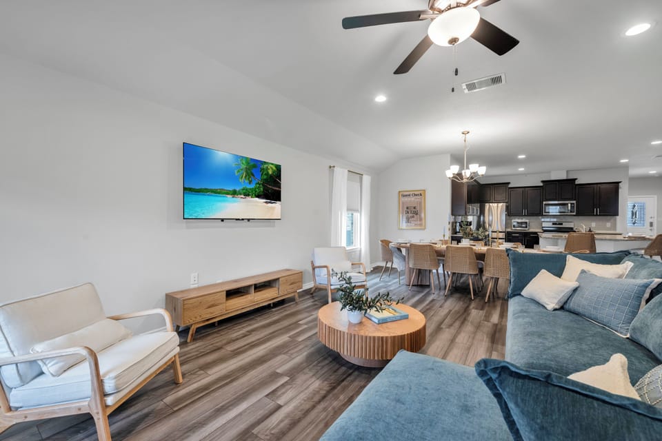 The open concept layout allows the living room to flow effortlessly into the dining and kitchen areas, creating the perfect setting for gathering and unwinding.