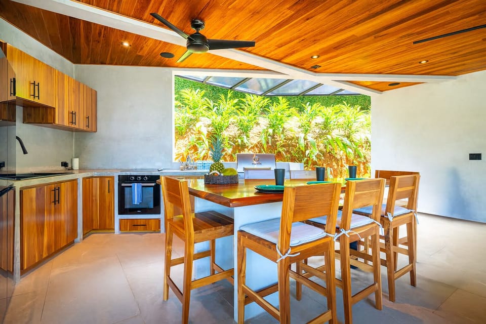 Outdoor full kitchen/BBQ, living room, half bath and yoga/exercise/weights area