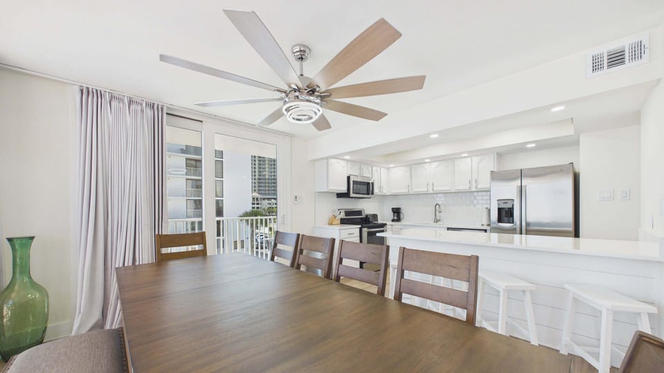 Dining area table with chair and bench seating + breakfast bar attached to kitchen counter