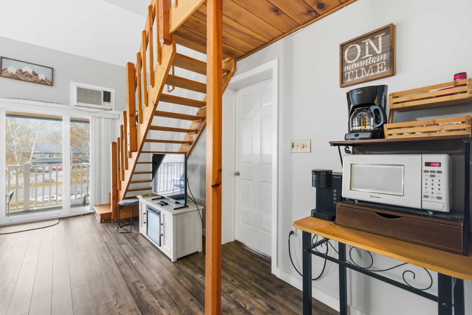 Your morning coffee spot meets mountain-inspired charm under soaring lofted ceilings.