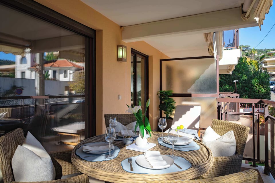 Balcony of Room 22: Private balcony with outdoor dining and lounge cushions — ideal for al fresco meals, wine nights, or remote work in the Mediterranean breeze.
