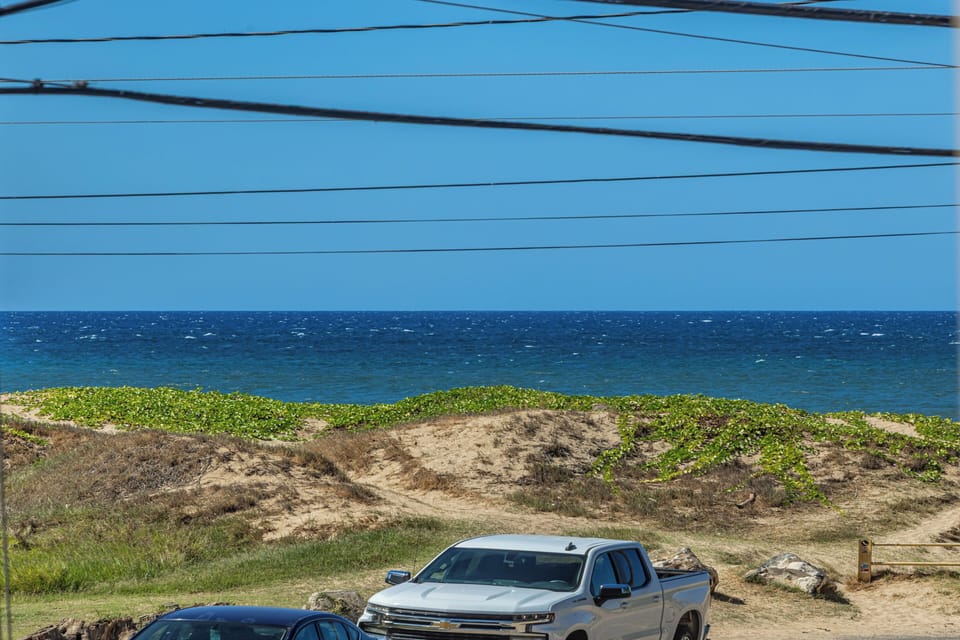 Coastal property with direct ocean proximity, set along sandy dunes and natural shoreline vegetation.