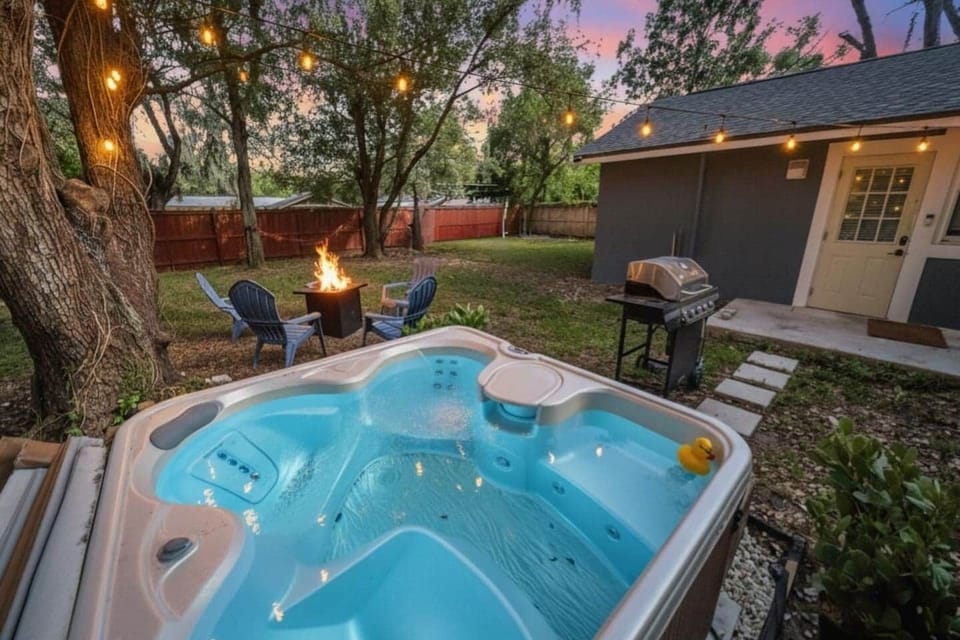 Outdoor area includes a four person hot tub, fire pit, and propane grill