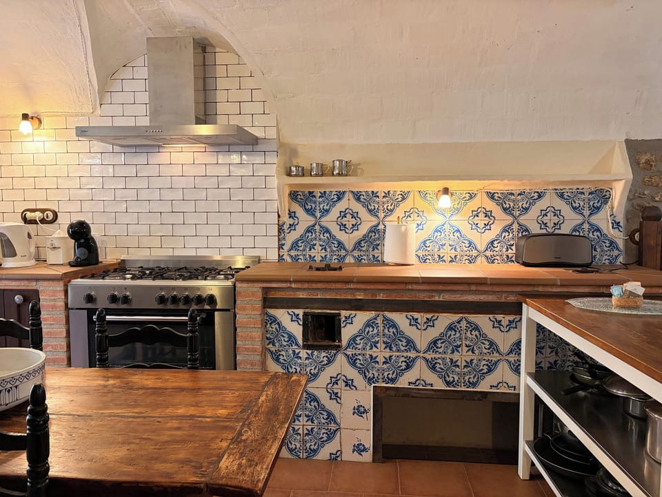 Discover the rustic charm of the fully equipped kitchen, featuring traditional Catalan tilework and modern appliances.