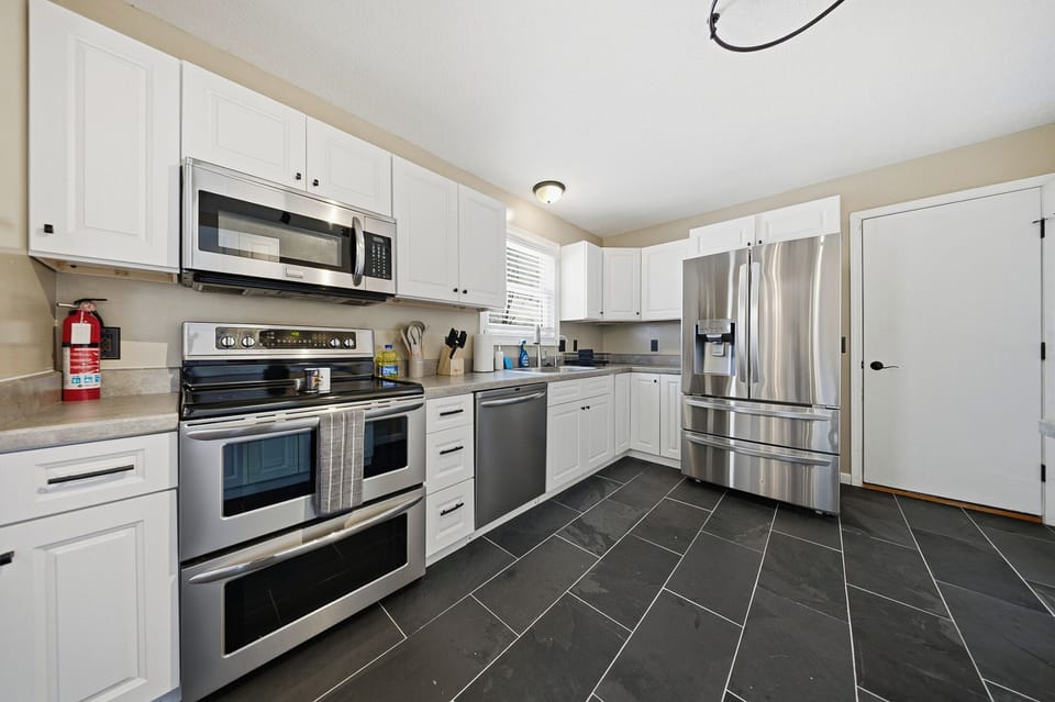 Custom-built kitchen with New electric burner stove and New refrigerator
