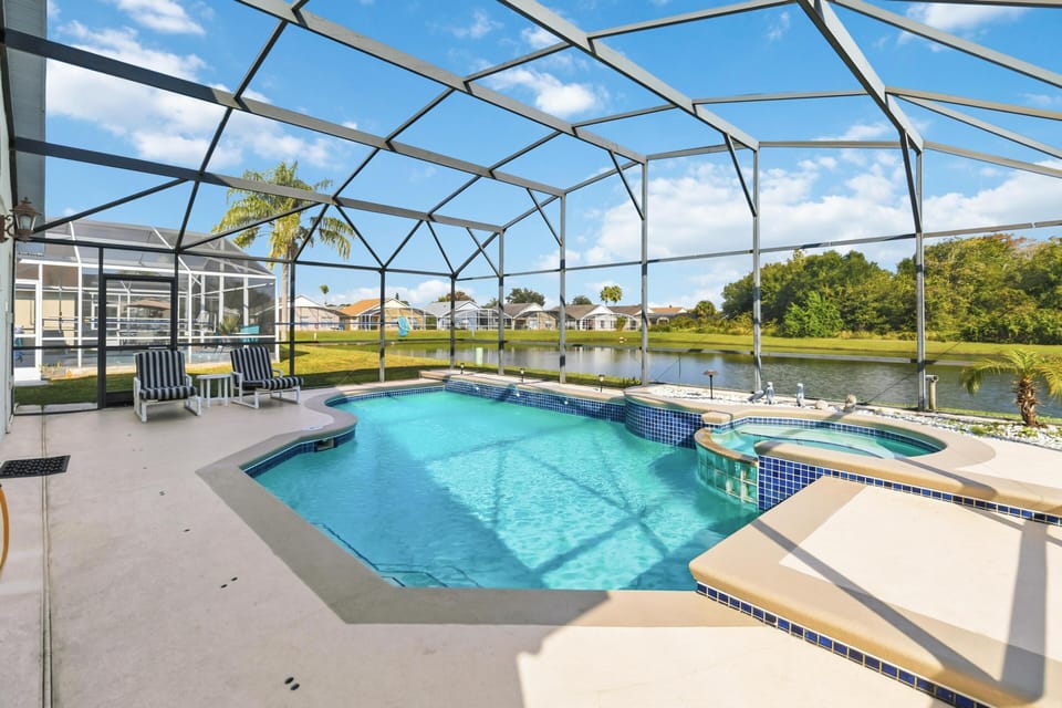 Sunlit screened pool area with lounge and dining space