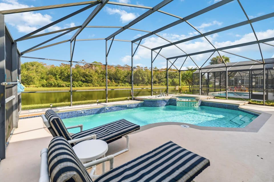 Sunlit screened pool area with cozy lounge seating