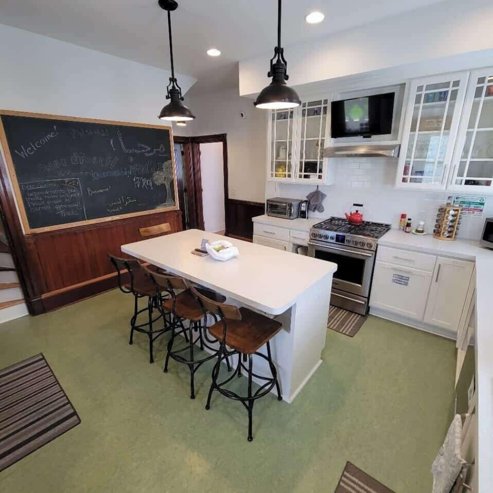 The completely renovated kitchen features a 5 burner stove, double drawer dishwasher, toaster oven, microwave, toaster, large refridgerator, television and coffee bar. This kitchen seats four at the kitchen island.