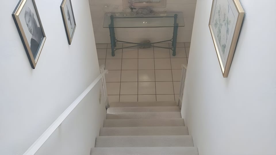 Stairway with Window View above showing mountains.