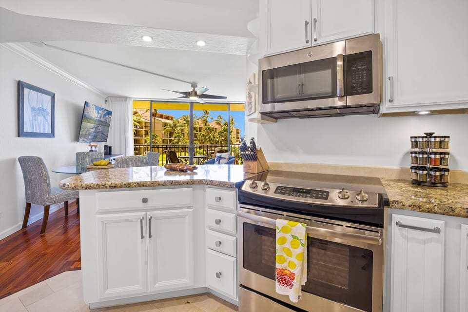 Cozy kitchen featuring granite countertops and stainless steel appliances. Everything you need to prepare meals, with a view of the outside!