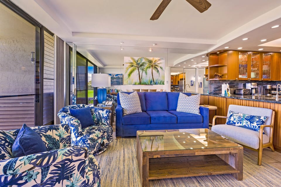Spacious open-concept lounge featuring plush tropical seating and cool tiled floors.
