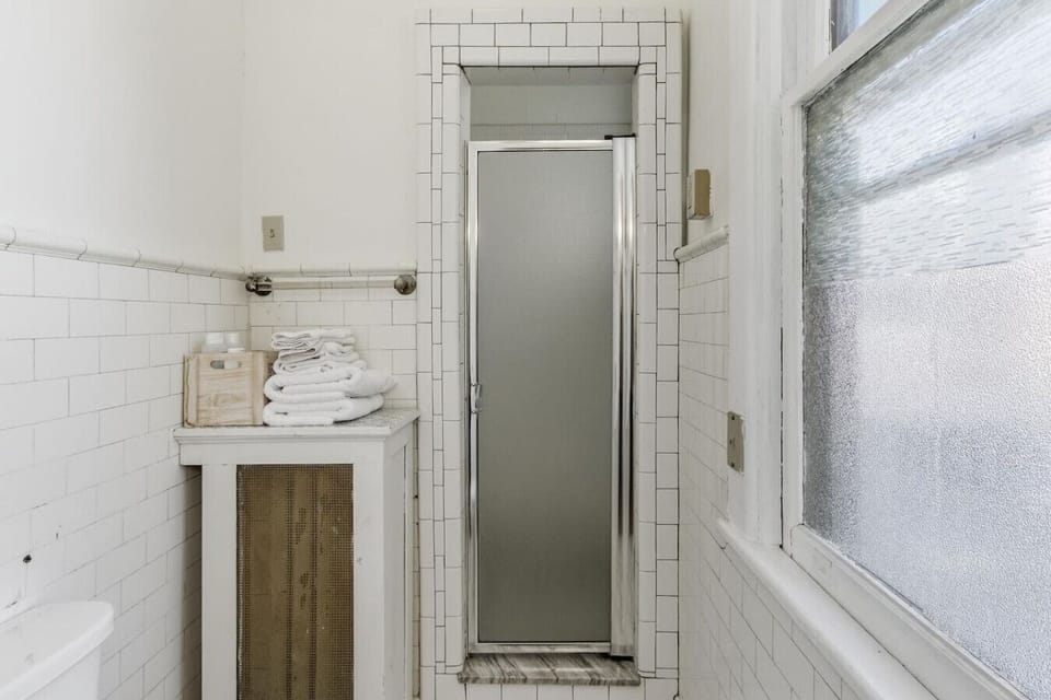 Enjoy a clean, simple shower space stocked with essentials for a comfortable stay.