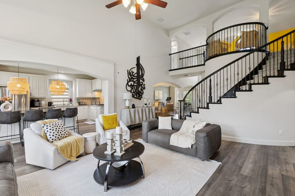 Grand Entrance: Soaring ceilings and a dramatic spiral staircase.