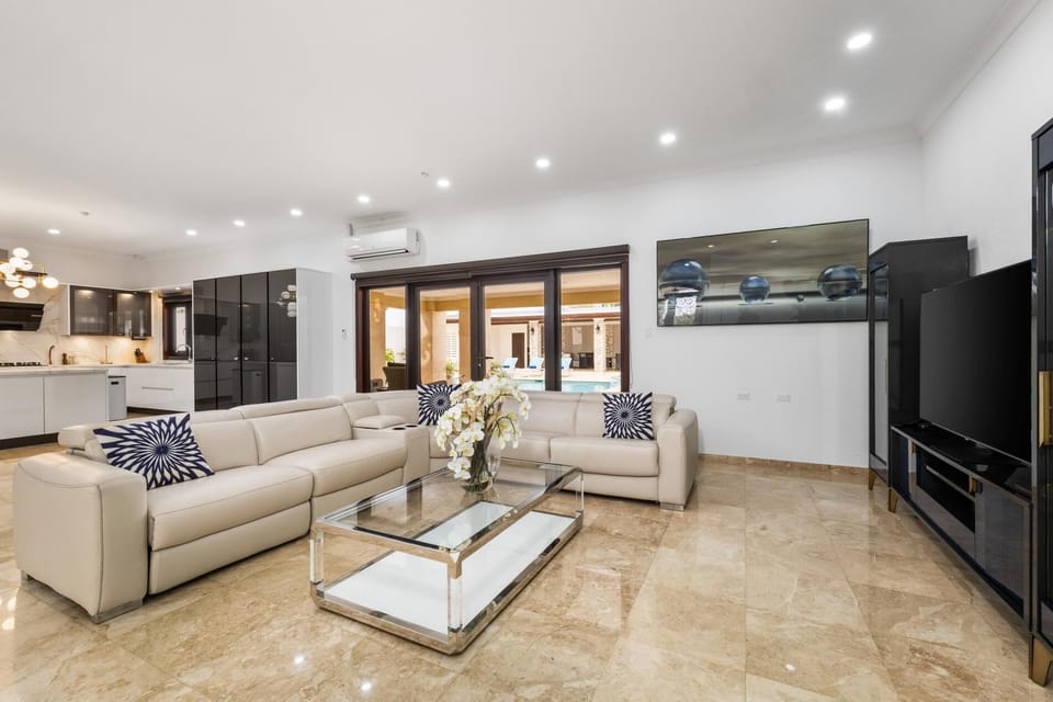 Live like royalty. Our spacious, modern living area features polished marble floors, high-end furnishings, and direct access to your private oasis. Enjoy movie night on the big screen, or slide open the doors for a breath of fresh air.