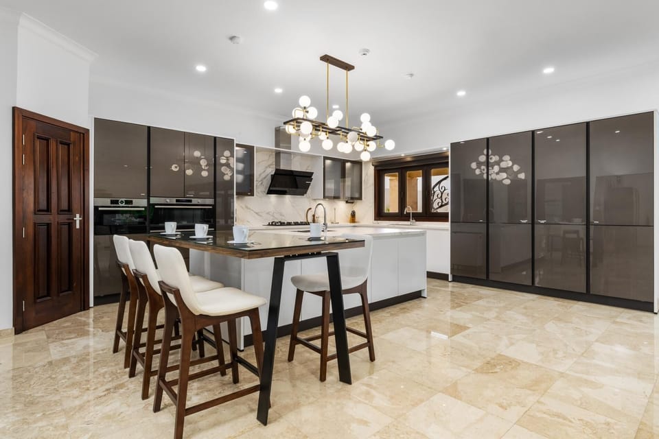 You'll move effortlessly from the state-of-the-art gourmet kitchen to the dazzling formal dining room with its show-stopping chandelier. Every meal is an event in a space designed for style and flow.