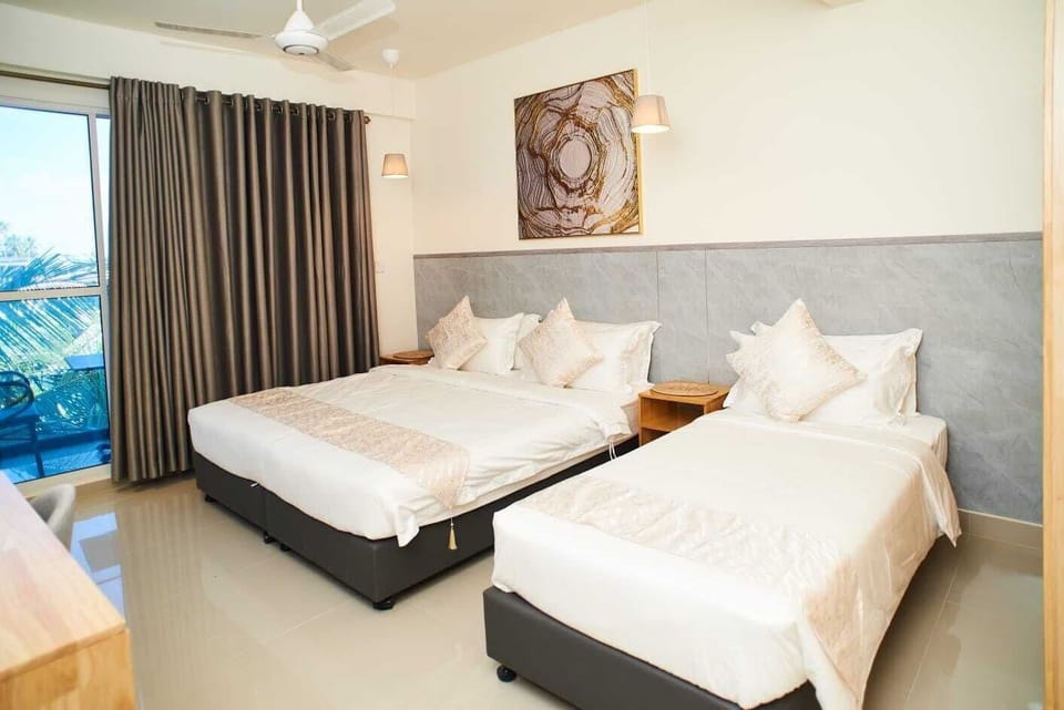 Deluxe Triple Room, City View | Desk, laptop workspace, iron/ironing board, free WiFi