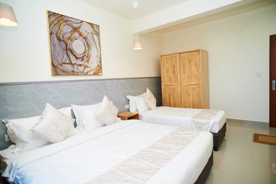 Deluxe Triple Room, City View | Desk, laptop workspace, iron/ironing board, free WiFi